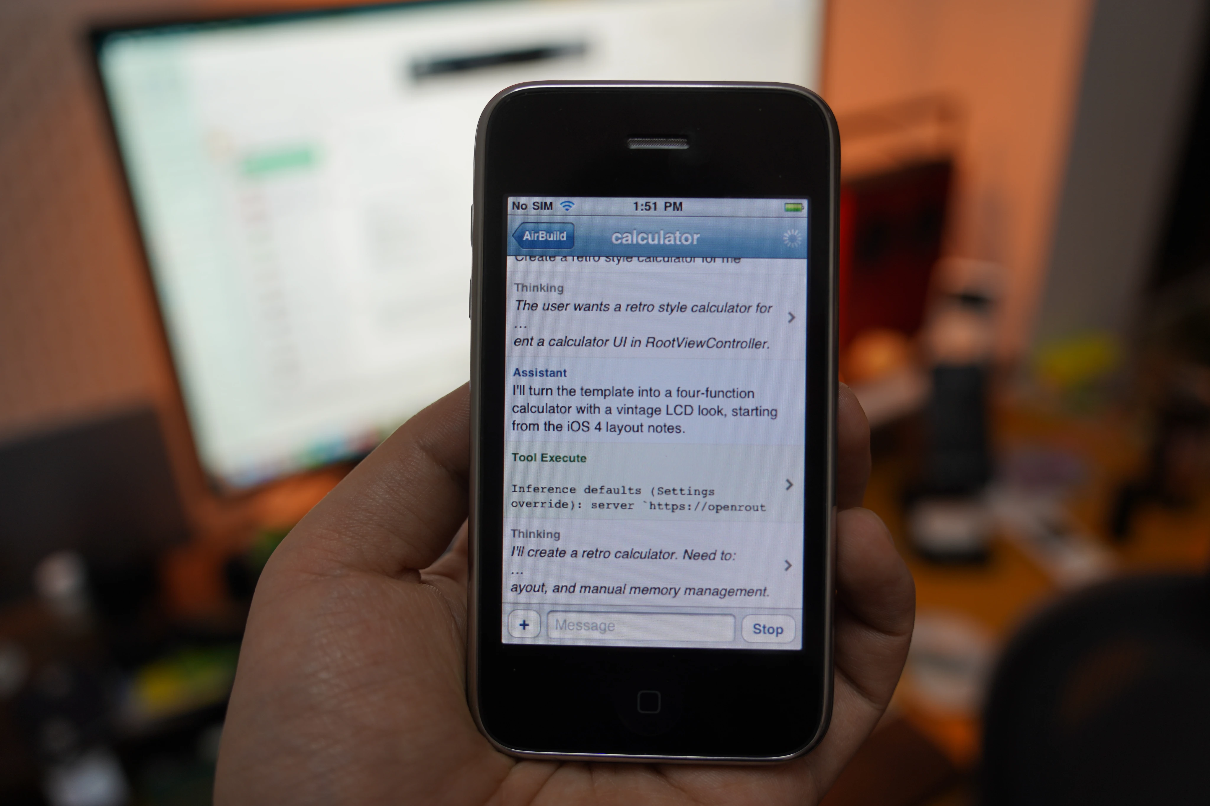 An iPhone held in hand with the AirBuild conversation open.