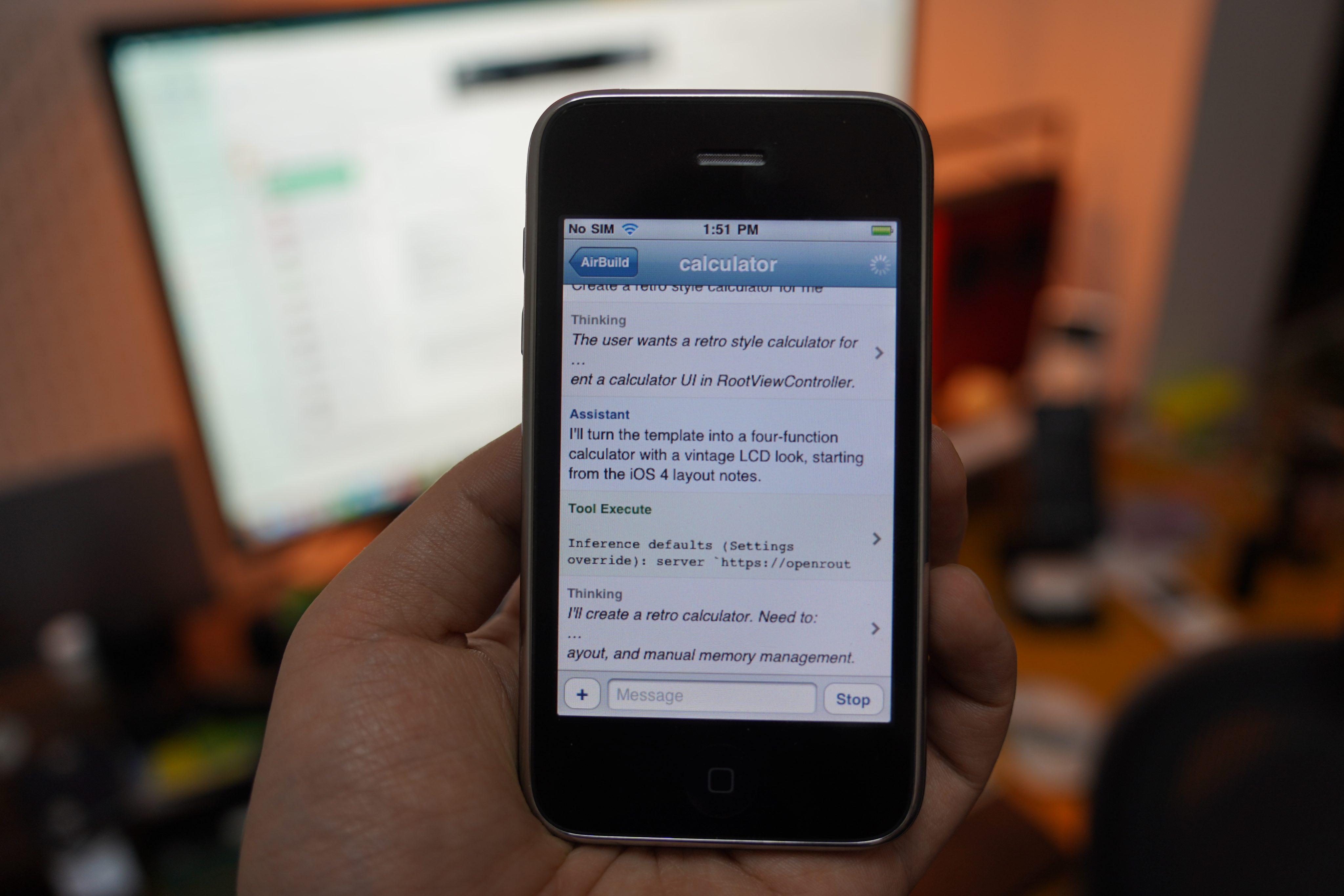 An iPhone held in hand with the AirBuild conversation open.